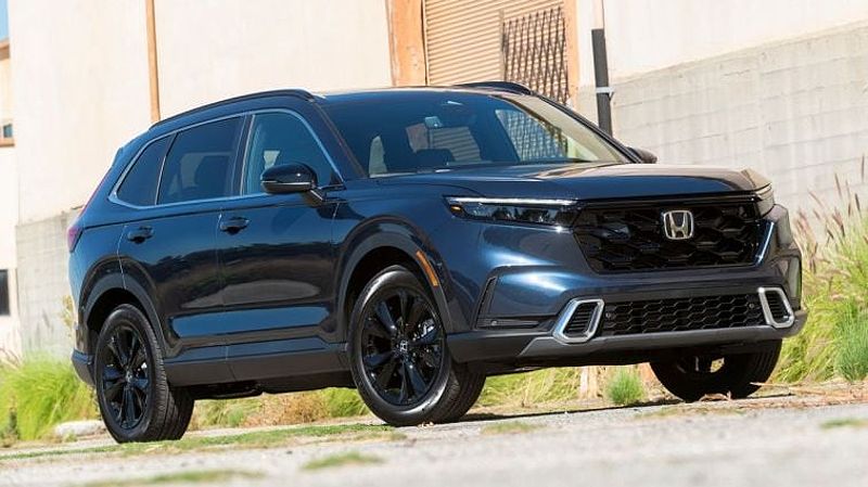 2024 Honda CR-V Hybrid next to a warehouse