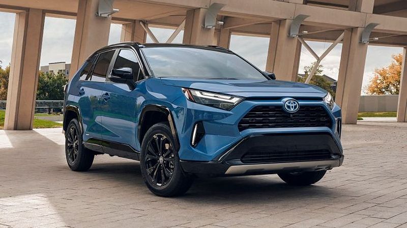 2024 Toyota RAV4 Hybrid XSE in blue near a bridge