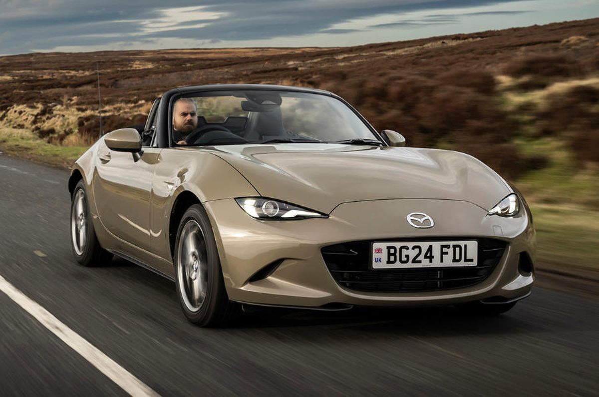 Mazda MX-5 Miata driving on the road